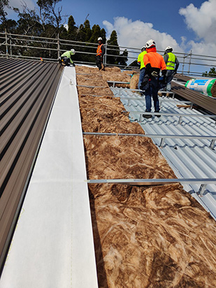 Warm roof insulation layer above structural deck Auckland